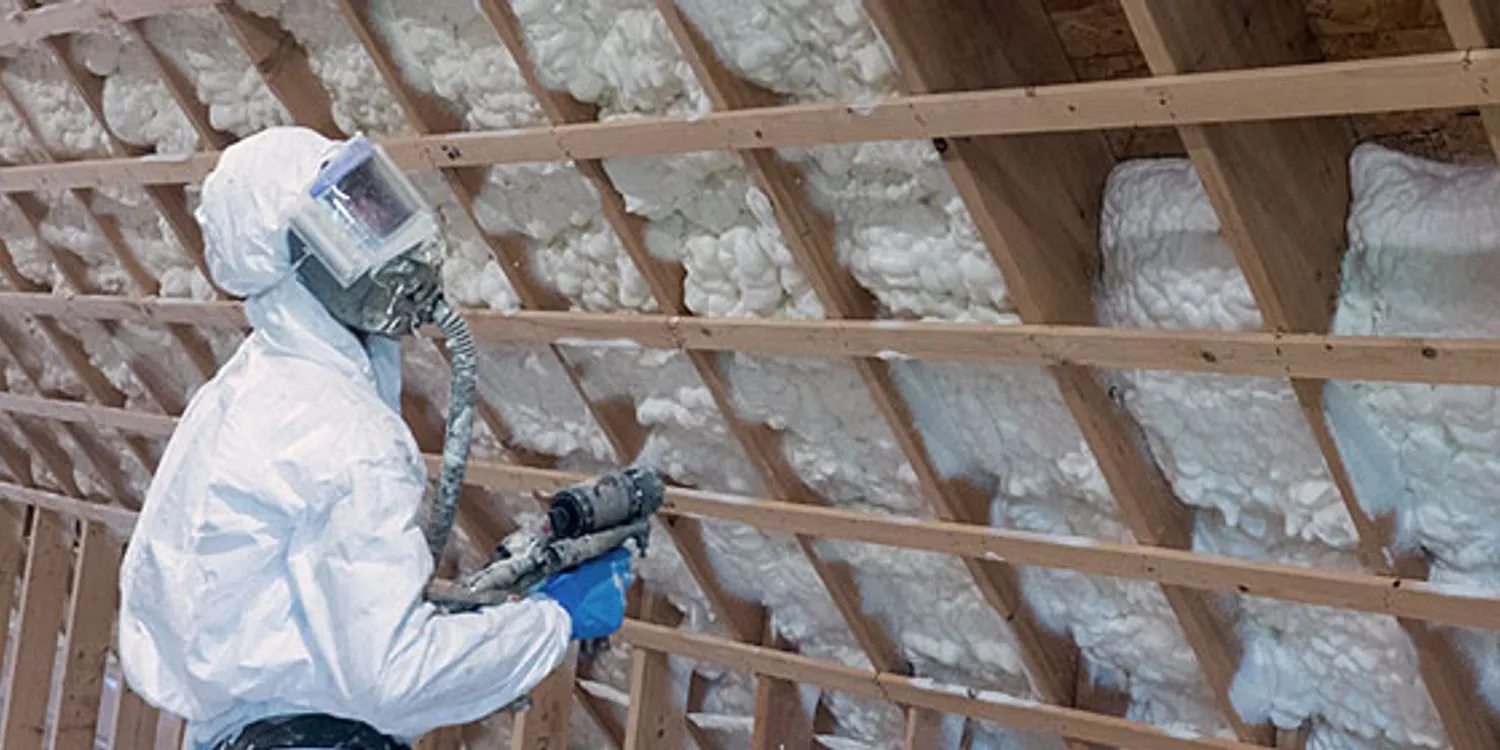 Professional installer applying spray foam insulation in an Arizona building